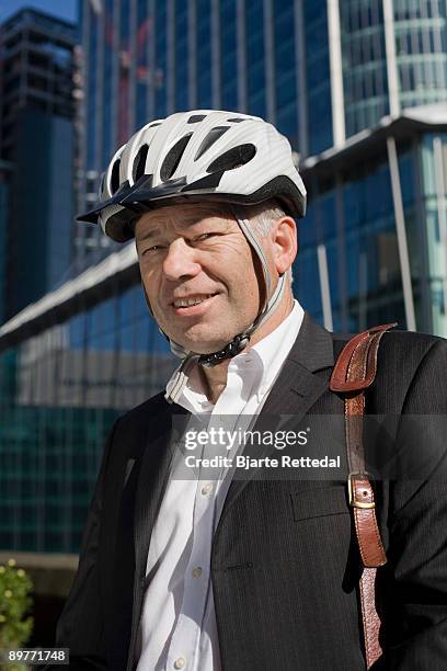 businessman in bicycle helmet - bjarte rettedal stock-fotos und bilder