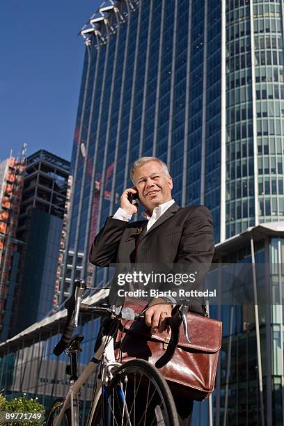 businessman commuting on bicycle - bjarte rettedal stock pictures, royalty-free photos & images