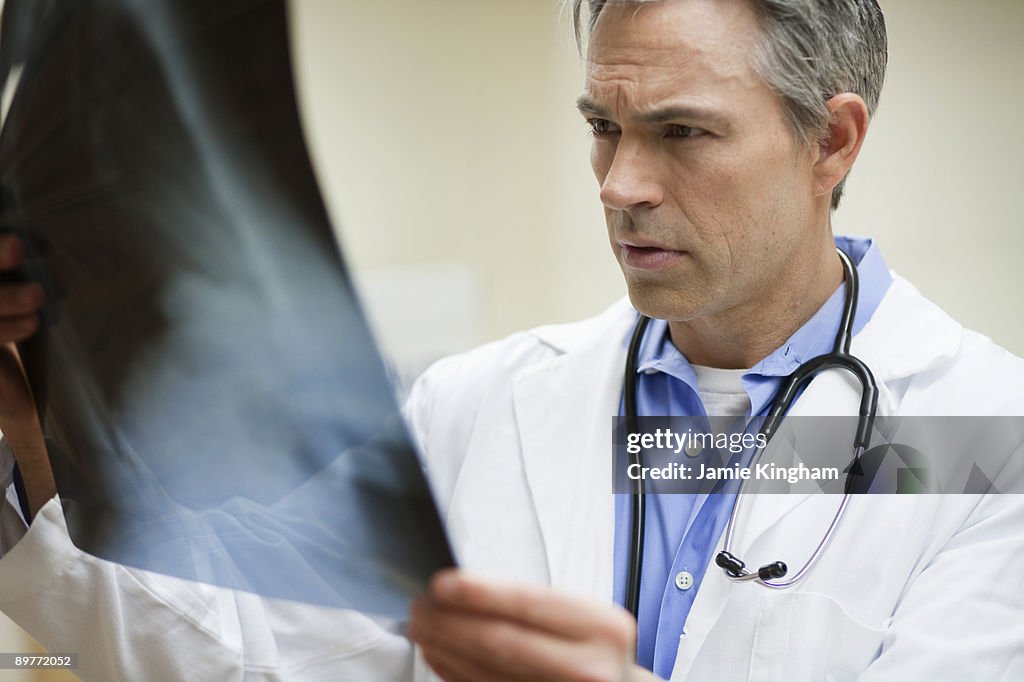 Male Doctor looking at x-ray