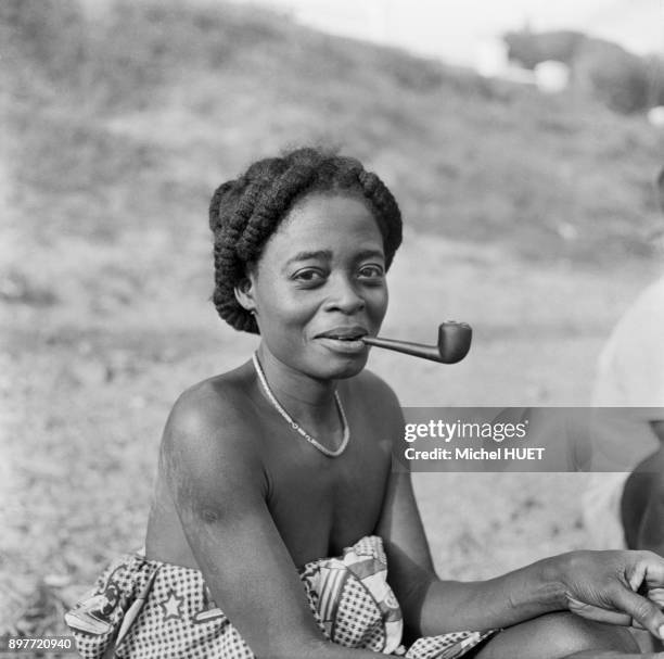 Femme fumant la pipe au Gabon, circa 1950.