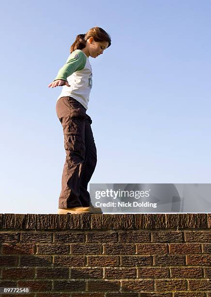 girl balancing on wall - 10-15 2004 stock pictures, royalty-free photos & images