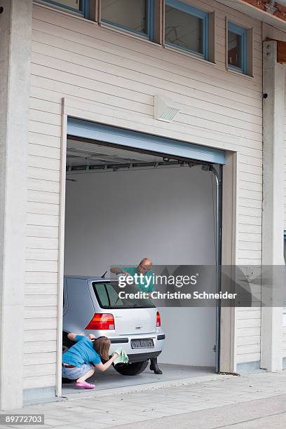 old man and young girl washing car - car home stock-fotos und bilder