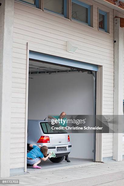 old man and young girl washing car - old garage at home stock pictures, royalty-free photos & images