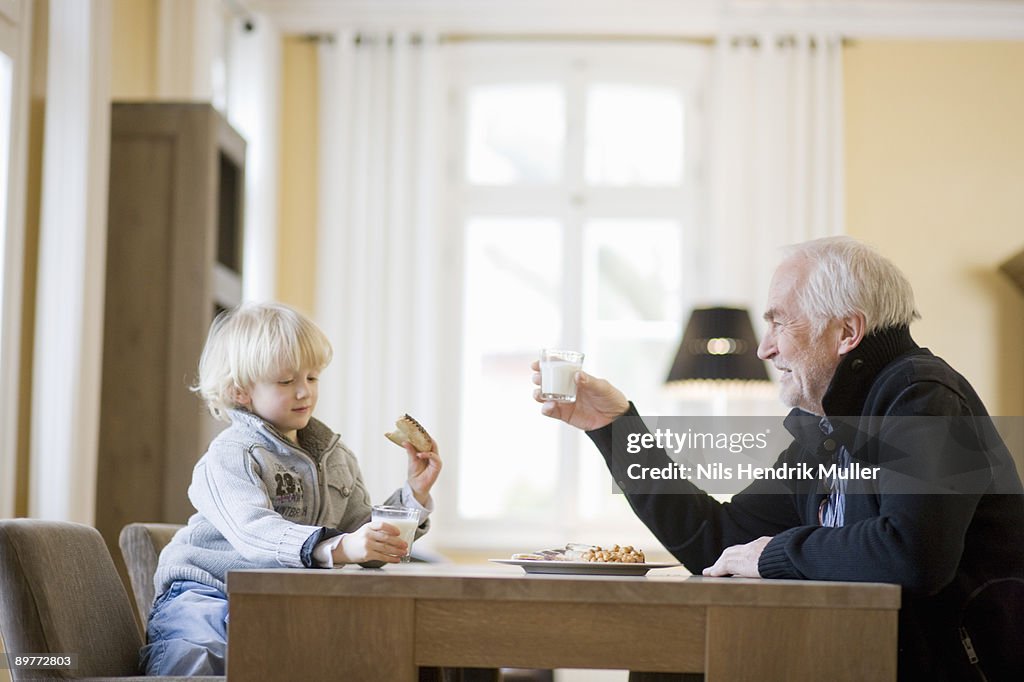 Grandson and grandfather eating