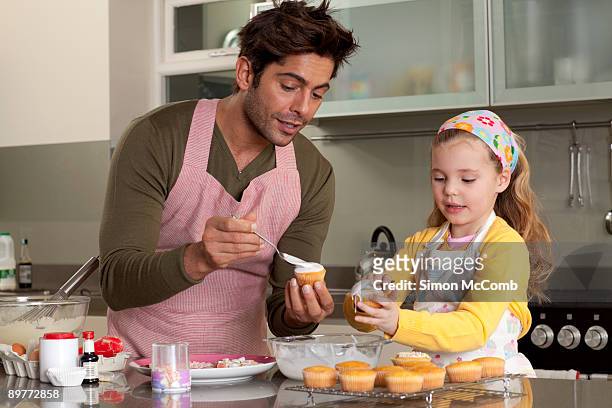father and daughter cooking - cupcakes girls fotografías e imágenes de stock