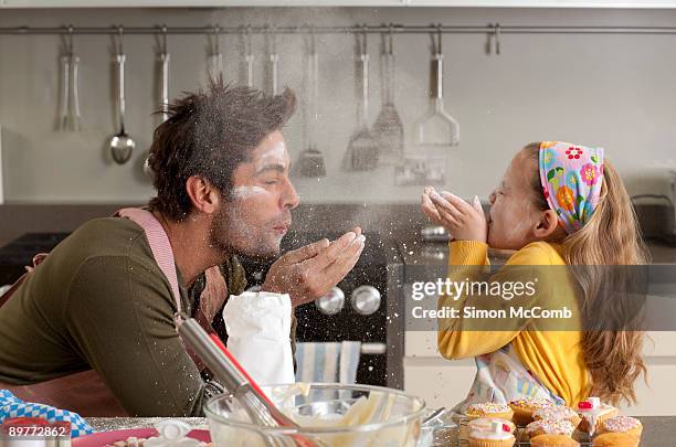 father and daughter cooking - children back stock-fotos und bilder