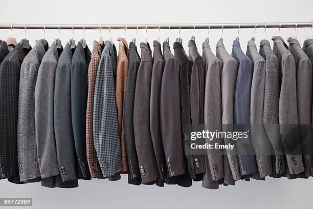 jackets on a pole - coat hanging stock pictures, royalty-free photos & images