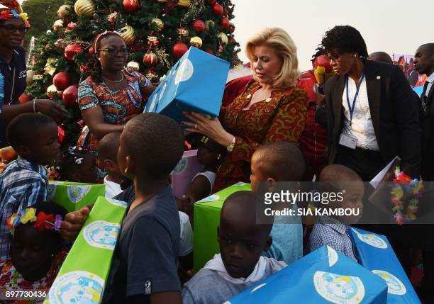 Ivory Coast's First Lady Dominique Ouattara distributes gifts to children at the presidential palace in Abidjan on December 23 during a Christmas...