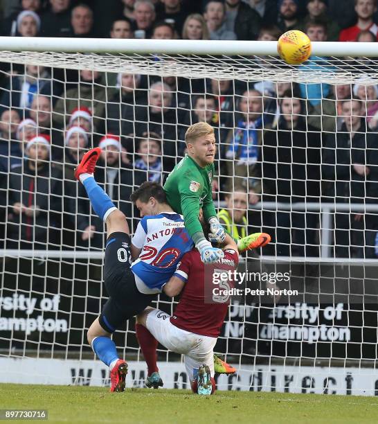 David Cornell of Northampton Town punches the the ball clear under pressure from Marcus Antonsson of Blackburn and team mate David Buchanan during...