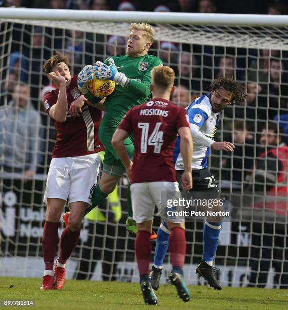 David Cornell of Northampton Town collects the ball under pressure from his team mate Ash Taylor and Bradley Dack of Blackburn Rovers during the Sky...