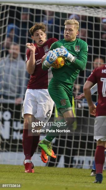 David Cornell of Northampton Town collects the ball under pressure from his team mate Ash Taylor during the Sky Bet League One match between...