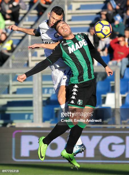Ivan Perisic of FC Internazionale Milano jumps for the ball against Federico Peluso of US Sassuolo Calcio during the serie A match between US...