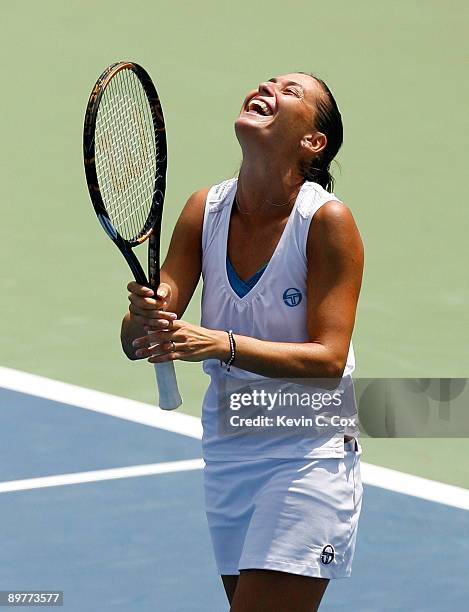 Flavia Pennetta of Italy reacts after defeating Venus Williams during Day 4 of the Western & Southern Financial Group Women's Open on August 13, 2009...