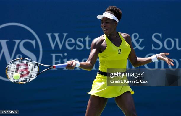 Venus Williams returns a shot to Flavia Pennetta of Italy during Day 4 of the Western & Southern Financial Group Women's Open on August 13, 2009 at...