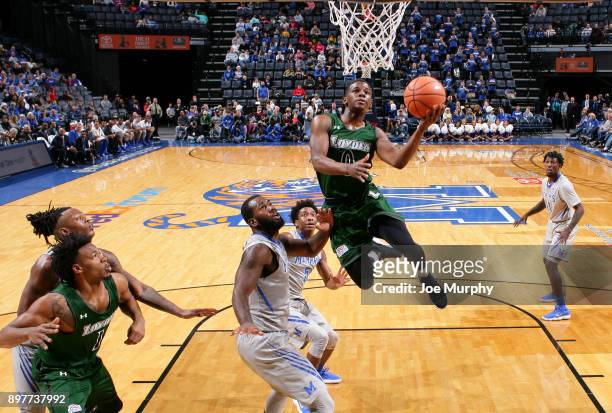 Isaiah Hart of the Loyola-Maryland Greyhounds drives to the basket for a layup against Raynere Thornton of the Memphis Tigers on December 23, 2017 at...