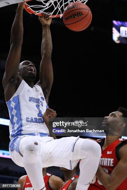 Theo Pinson of the North Carolina Tar Heels dunks against Keita Bates-Diop of the Ohio State Buckeyes during the second half of the CBS Sports...