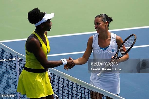 Venus Williams congratulates Flavia Pennetta of Italy after their match on Day 4 of the Western & Southern Financial Group Women's Open on August 13,...