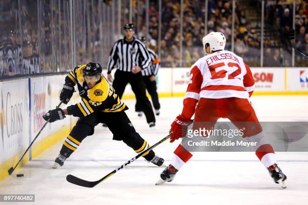 Brad Marchand of the Boston Bruins skates against Jonathan Ericsson of the Detroit Red Wings during the third period at TD Garden on December 23,...