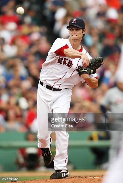 Clay Buchholz of the Boston Red Sox throws to first base in the first inning during the game against the Detroit Tigers at Fenway Park on August 13,...