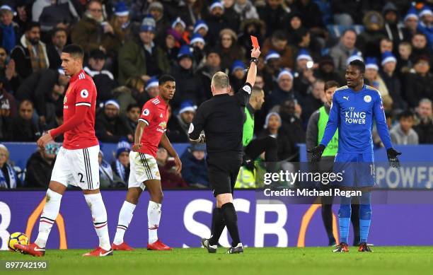 Daniel Amartey of Leicester City is shown the red card by referee Jonathan Moss during the Premier League match between Leicester City and Manchester...