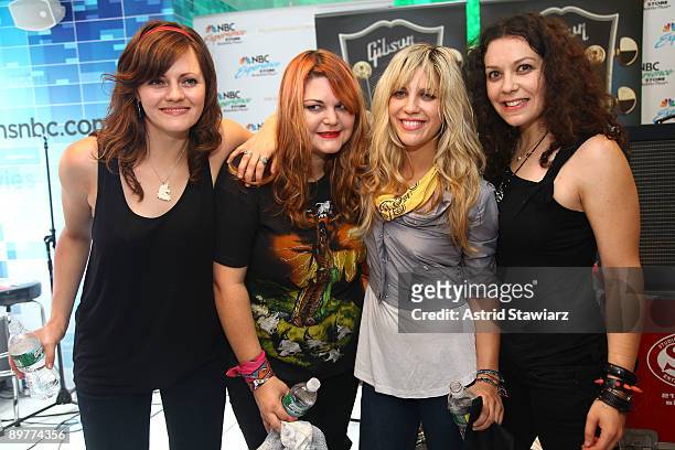 Brett Anderson, Maya Ford, Allison Robertson and Amy Cesari of The Donnas pay tribute to Les Paul at the NBC Experience Store as part of the Gibson...
