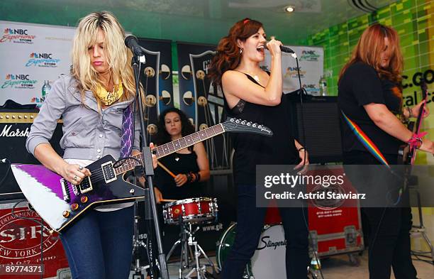 Allison Robertson, Amy Cesari, Brett Anderson and Maya Ford of The Donnas pay tribute to Les Paul at the NBC Experience Store as part of the Gibson...