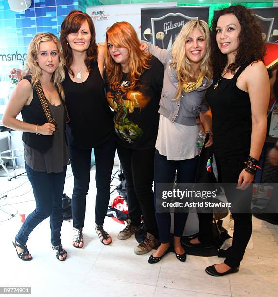 Torry Castellano, Brett Anderson, Maya Ford, Allison Robertson and Amy Cesari of The Donnas pay tribute to Les Paul at the NBC Experience Store as...