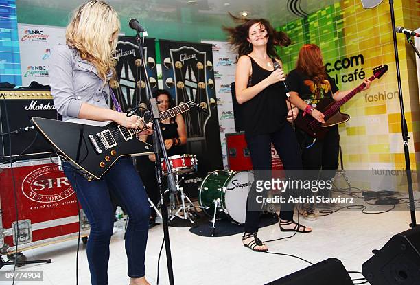 Allison Robertson, Amy Cesari, Brett Anderson and Maya Ford of The Donnas pay tribute to Les Paul at the NBC Experience Store as part of the Gibson...