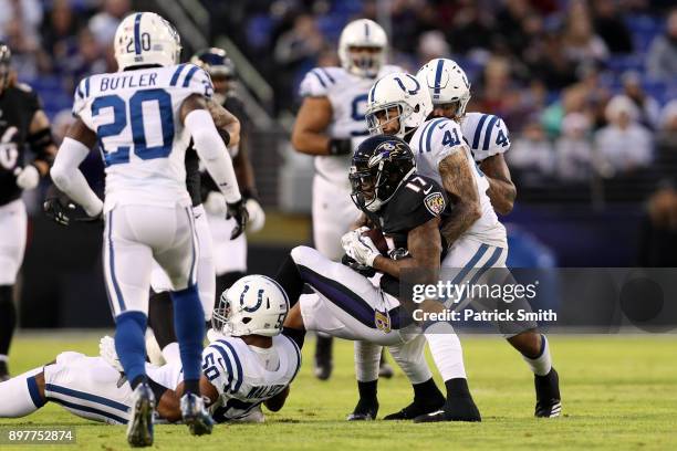 Wide Receiver Mike Wallace of the Baltimore Ravens is tackled after a reception by strong safety Matthias Farley of the Indianapolis Colts in the...