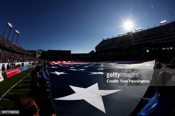 Volunteers hold an American flag during the National Anthem before Army Black Knights takes on the San Diego State Aztecs in the Lockheed Martin...