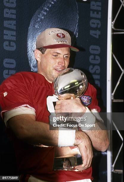 Steve Young of the San Francisco 49ers holds the Vince Lombardi trophy after the 49ers defeated the San Diego Chargers in Super Bowl XXIX on January...