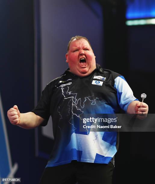 John Henderson of Scotland celebrates after winning the second round match against Daryl Gurney of Northern Ireland on day ten of the 2018 William...