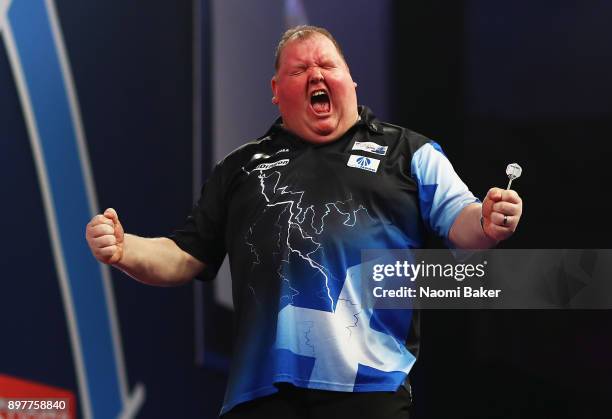 John Henderson of Scotland celebrates after winning the second round match against Daryl Gurney of Northern Ireland on day ten of the 2018 William...