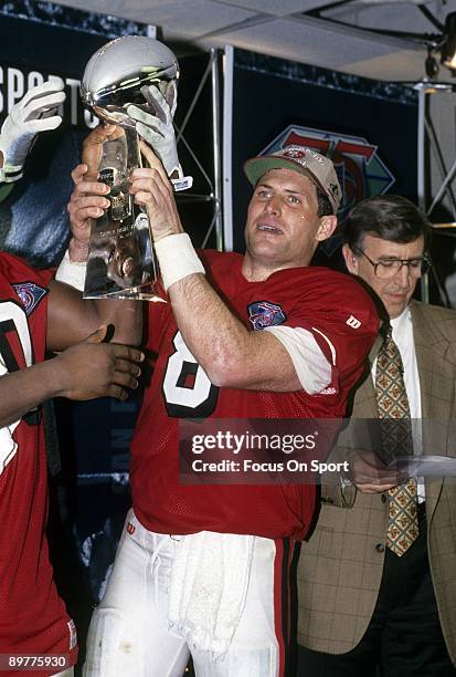 Steve Young of the San Francisco 49ers holds the Vince Lombardi trophy after the 49ers defeated the San Diego Chargers in Super Bowl XXIX on January...