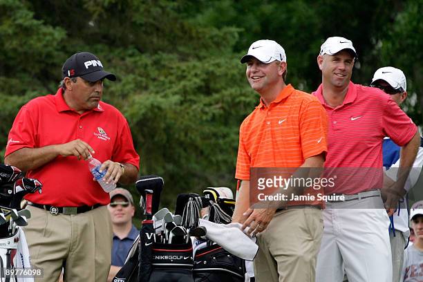 Angel Cabrera of Argentina, Lucas Glover and Stewart Cink wait on the seventh tee during the first round of the 91st PGA Championship at Hazeltine...