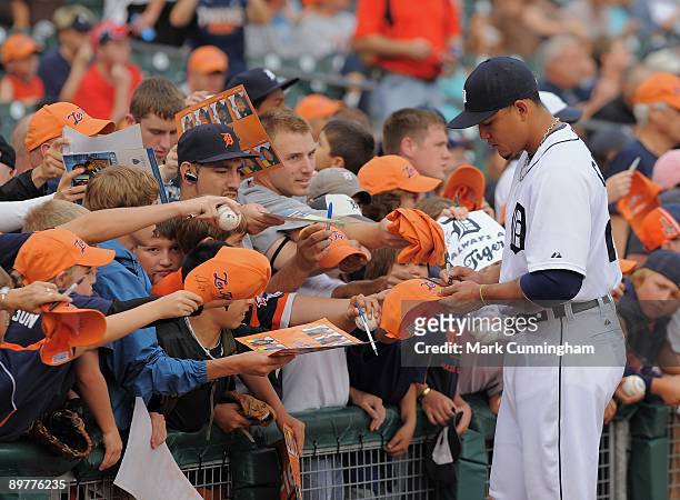 Miguel Cabrera of the Detroit Tigers signs autographs for fans before the game against the Minnesota Twins at Comerica Park on August 8, 2009 in...