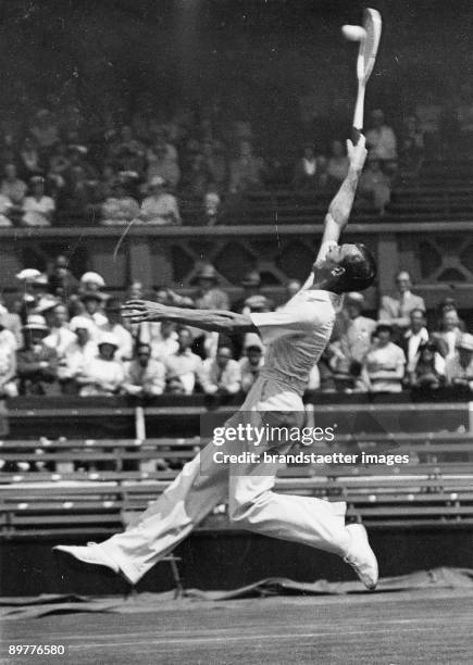 The world champion and Wimbledon titleholder Fred J. Perry during his match against the Canadian tennis player M. Rainville at Wimbledon. Photograph....