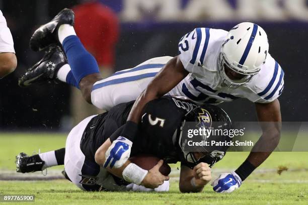 Quarterback Joe Flacco of the Baltimore Ravens is sacked by outside linebacker Barkevious Mingo of the Indianapolis Colts in the second quarter at...