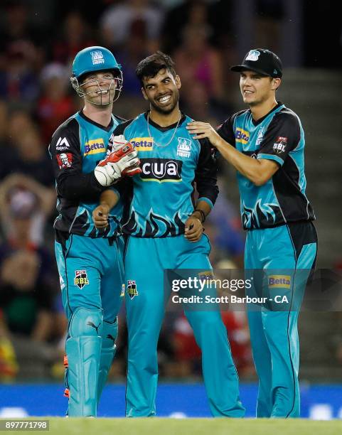 Shadab Khan of the Heat is congratulated by his teammates after dismissing Marcus Harris of the Renegades during the Big Bash League match between...