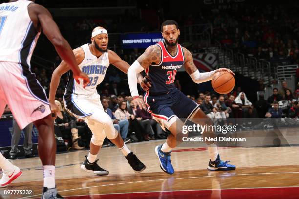 Mike Scott of the Washington Wizards handles the ball against Adreian Payne of the Orlando Magic on December 23, 2017 at Capital One Arena in...