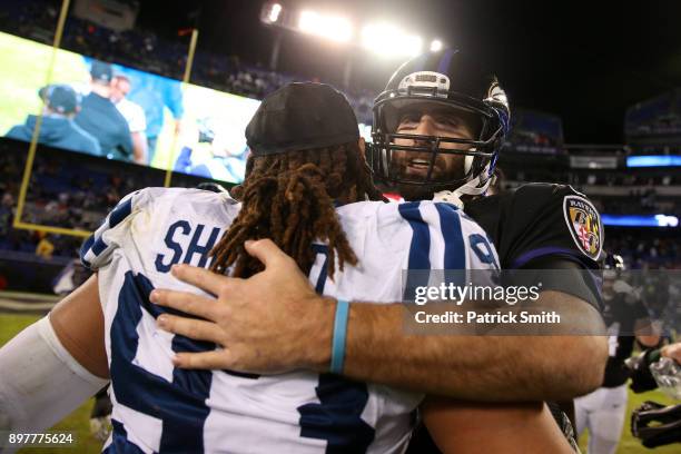 Quarterback Joe Flacco of the Baltimore Ravens and outside linebacker Jabaal Sheard of the Indianapolis Colts hug after the Baltimore Ravens 23-16...