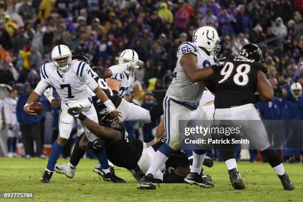 Quarterback Jacoby Brissett of the Indianapolis Colts throws the ball as he is tackled in the fourth quarter against the Baltimore Ravens at M&T Bank...