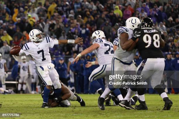 Quarterback Jacoby Brissett of the Indianapolis Colts throws the ball as he is tackled in the fourth quarter against the Baltimore Ravens at M&T Bank...