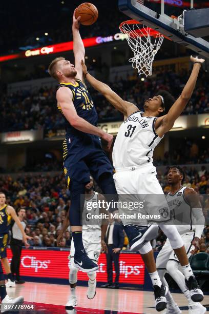 Domantas Sabonis of the Indiana Pacers dunks the ball against Jarrett Allen of the Brooklyn Nets during the first half at Bankers Life Fieldhouse on...