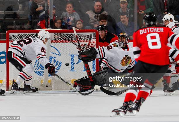 Corey Crawford of the Chicago Blackhawks surrenders a first period goal against Pavel Zacha of the New Jersey Devils on December 23, 2017 at...