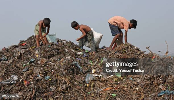 Children collect rubbish for resale. At the end of the day, they earn TK 60-80 . The Matuail dump yard is one of the three waste sites of Dhaka, a...