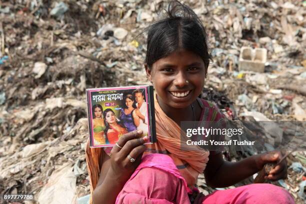 The girl is very happy because she finds her favourite artists CD album from dump yard. She collects rubbish for sale. At the end of the day, she...