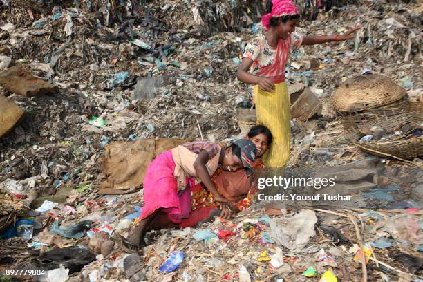 Children from indigent community at garbage pile in Matual dumping yard. They collect usable things that are sold to make recycling products....