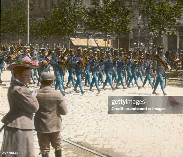 Musicians of the Viennese Hoch- und Deutschmeister, the so-called "Burgmusik" marching at the Ringstrasse. Vienna, first district. Hand-colored...