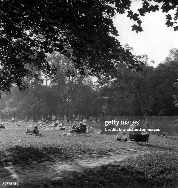 Sunday afternoon. People lying in the gras. Vienna. Prater. Photograph around 1930